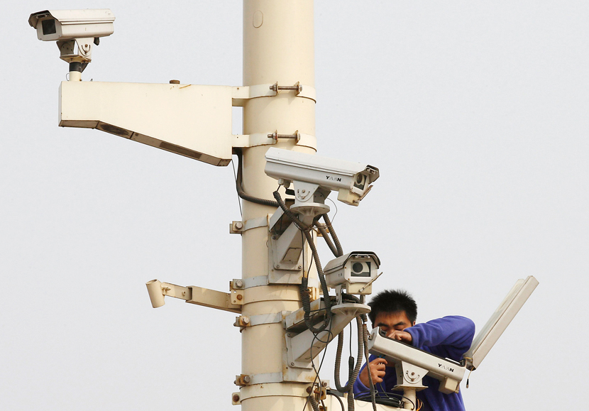 A man works on a security camera